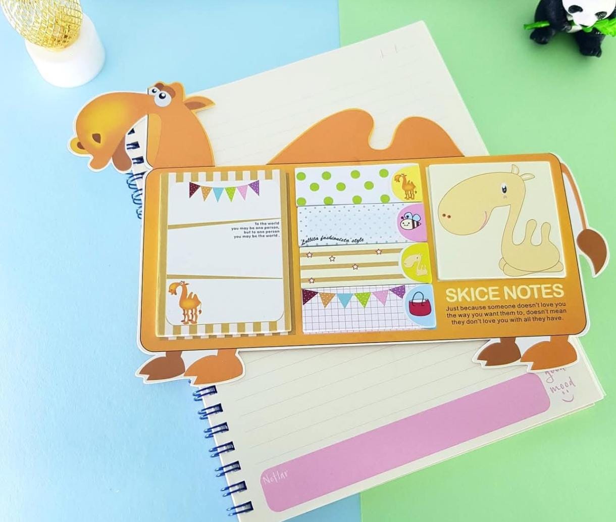Notebook with cartoon animal design on a colorful background