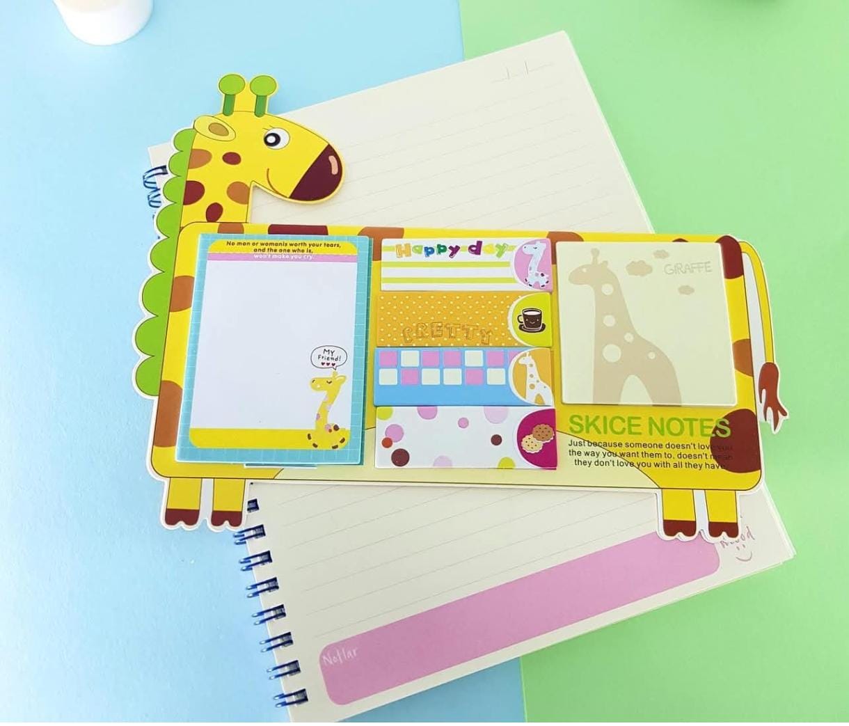 Colorful notepad with a giraffe design on a multicolored background