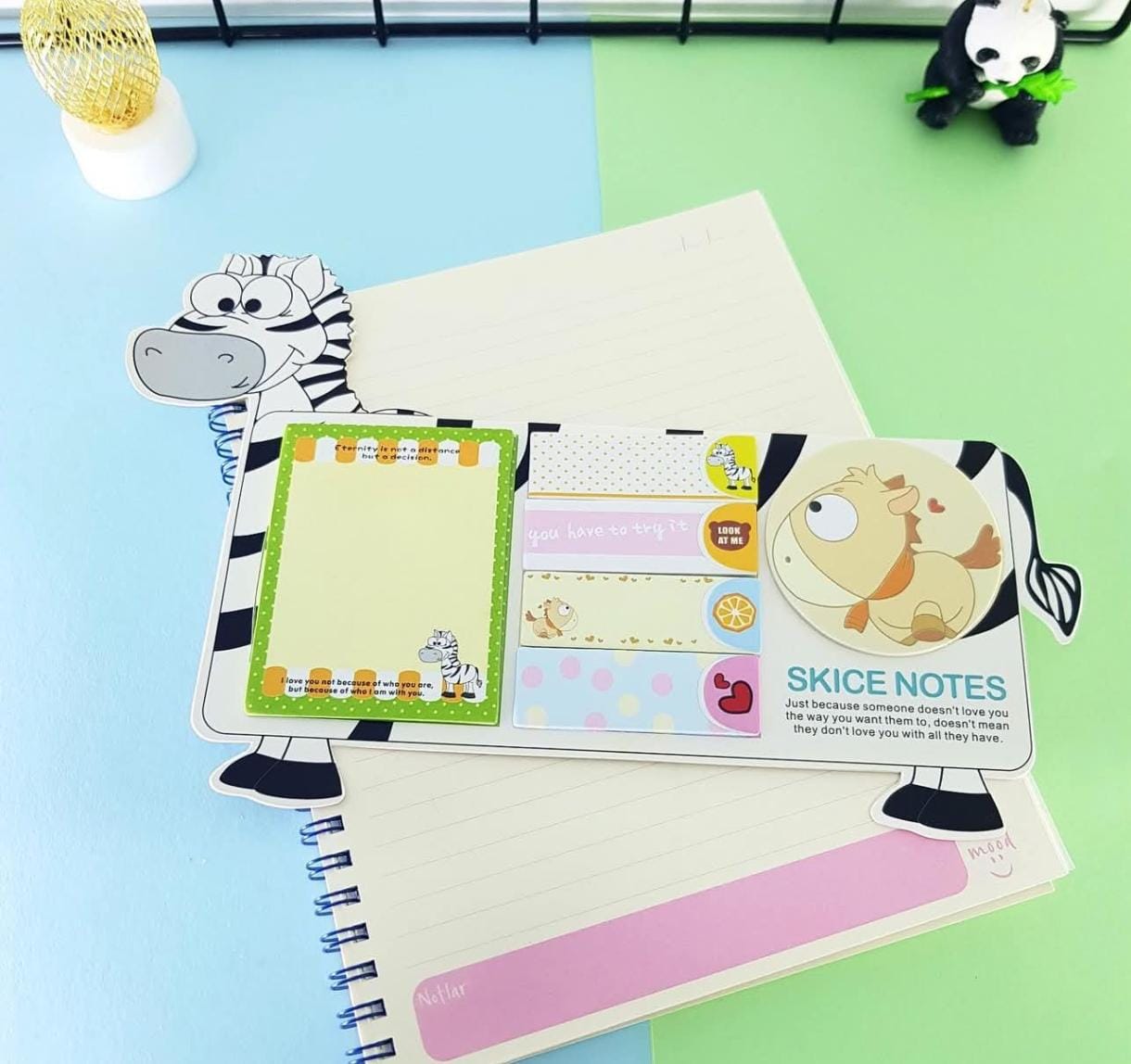Notebook with zebra-themed stationery items on a colorful background