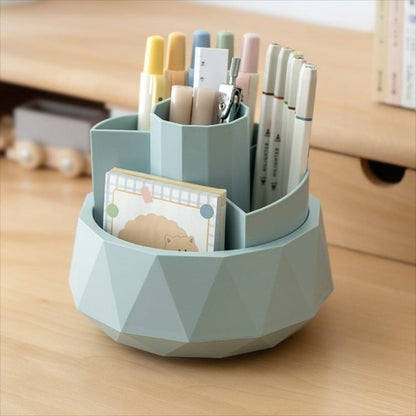Geometric pen holder with stationery items on a wooden surface