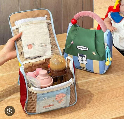 Baby care bag with bottles and accessories on a wooden surface