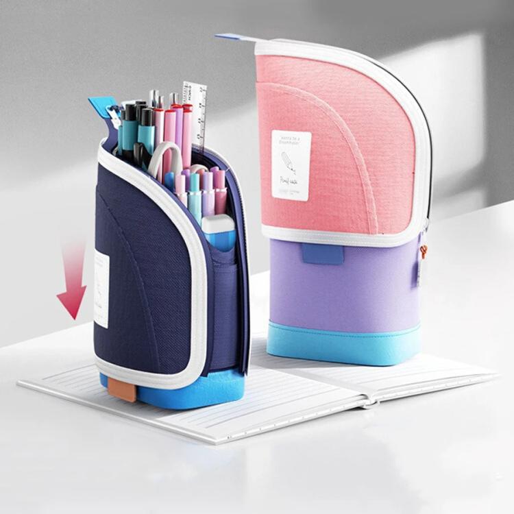 Colorful pen holder with stationery items on a white surface