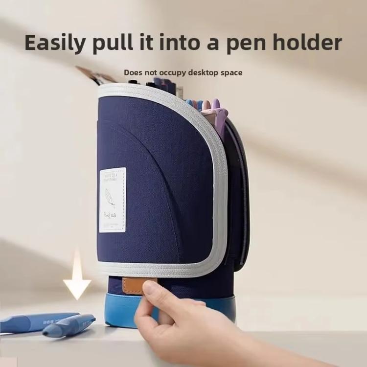 Navy blue pen holder with a hand interacting with it on a light background