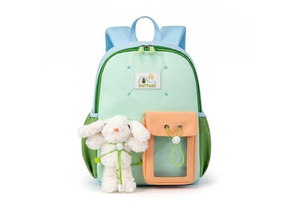 Children's backpack with a toy sheep attached on a white background