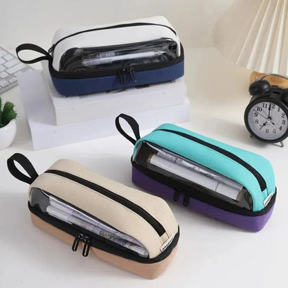 Three transparent pencil cases in different colors on a desk with stationery items.