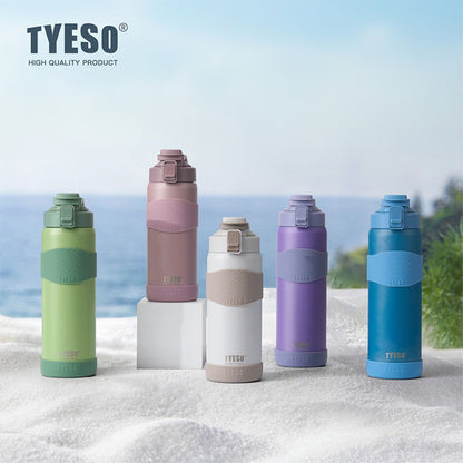 Five colorful TYESO water bottles on a beach with ocean view